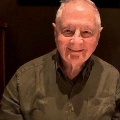 Headshot of Peter Ellyard smiling and wearing a khaki green business shirt