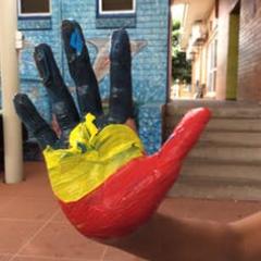 Painted aboriginal flag on childs hand
